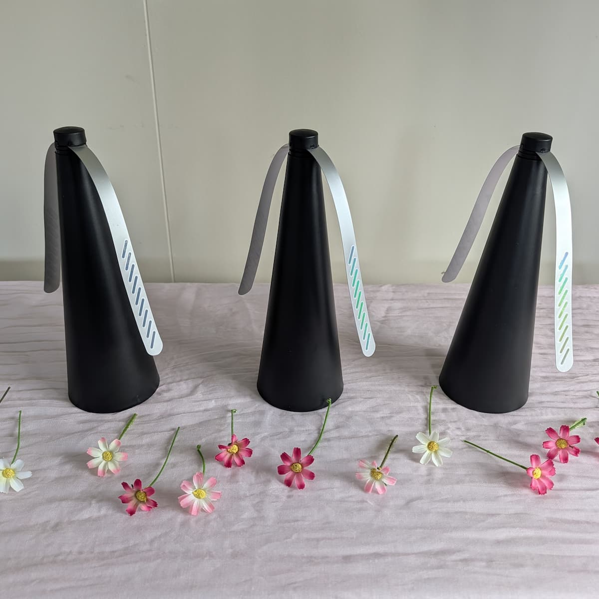 Three black cone holders with 