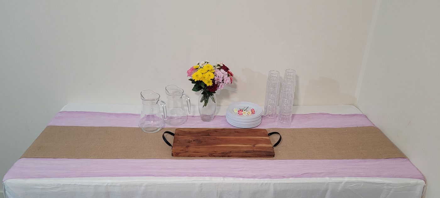 Styled party table with trestle, runners, plates and centrepiece