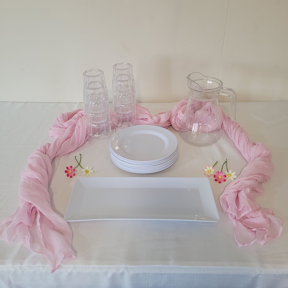 Styled starter setup with side plates, tumblers and a runner