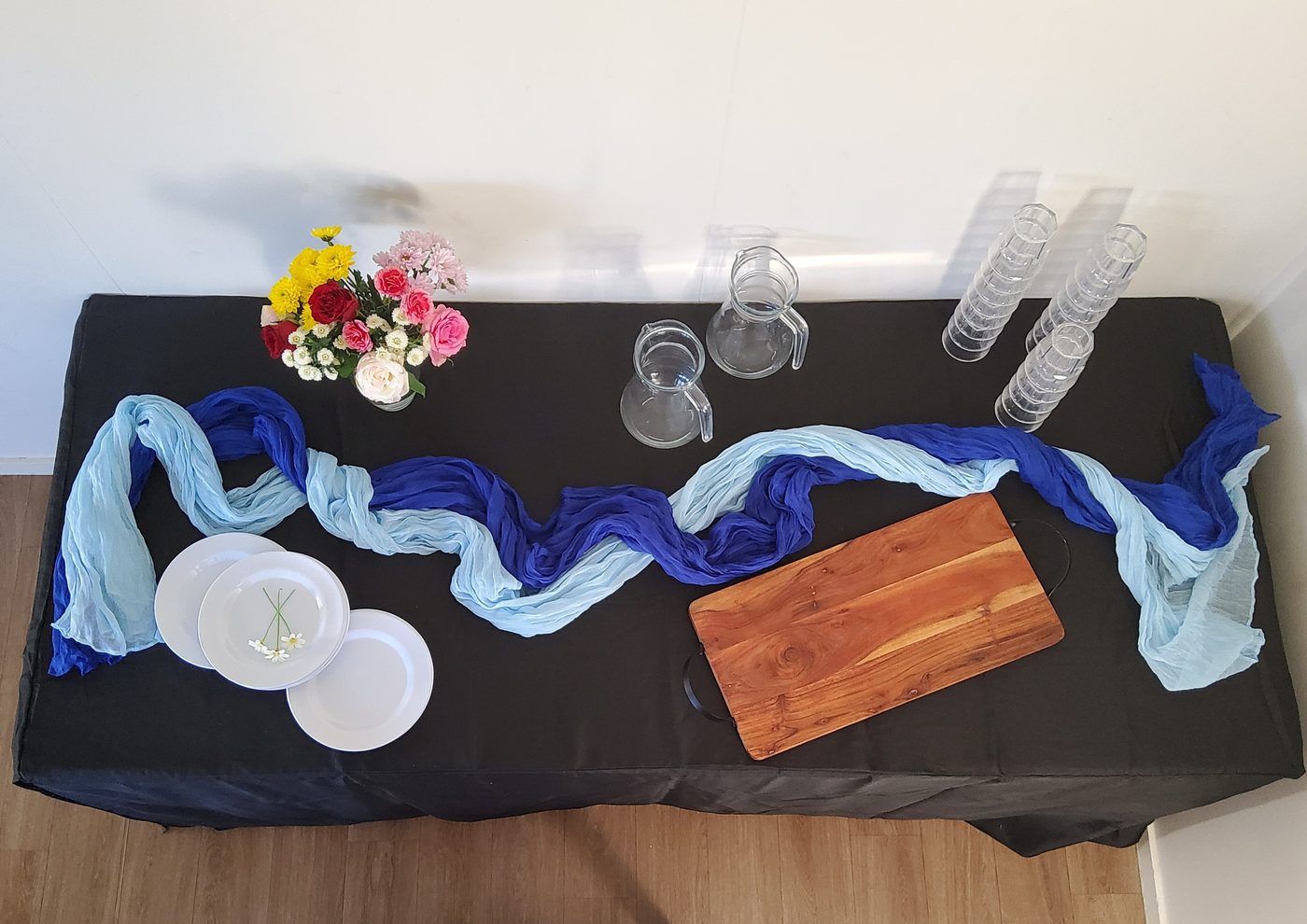 Party table with blue and light blue cheesecloth runners