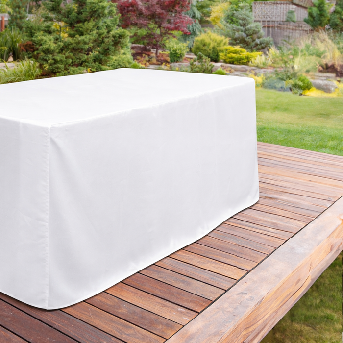 Trestle table with white floor-length tablecloth outdoors