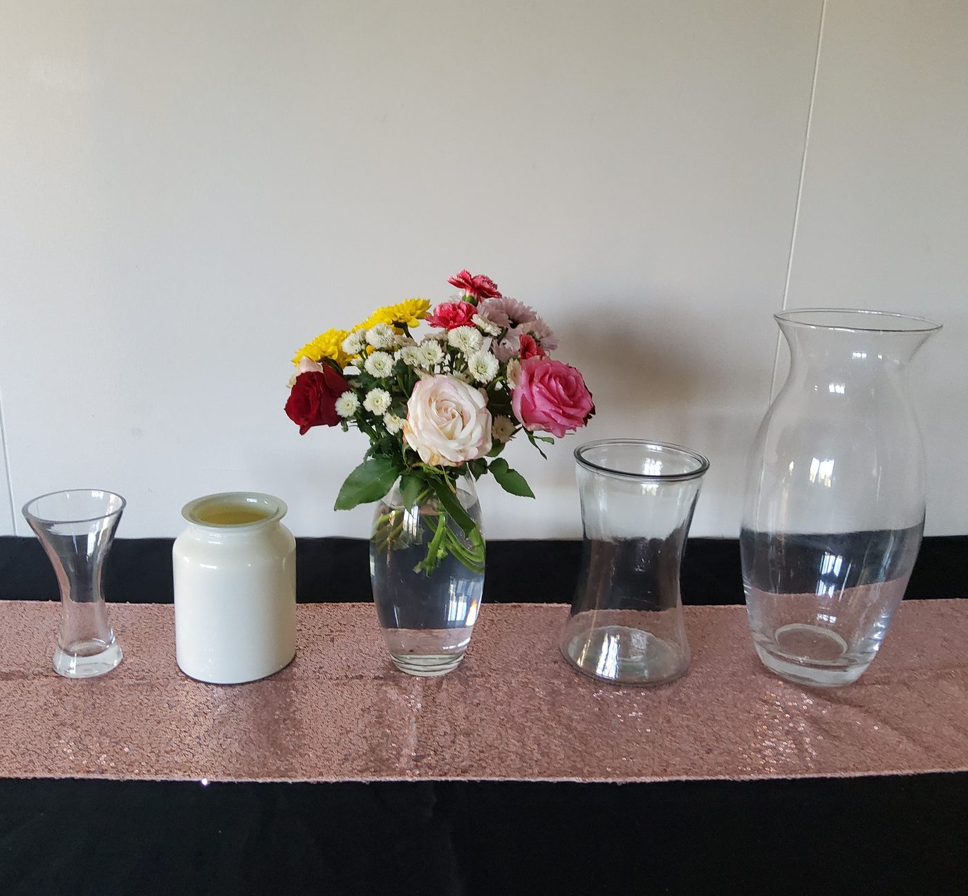 Collection of five glass vases in different shapes and sizes